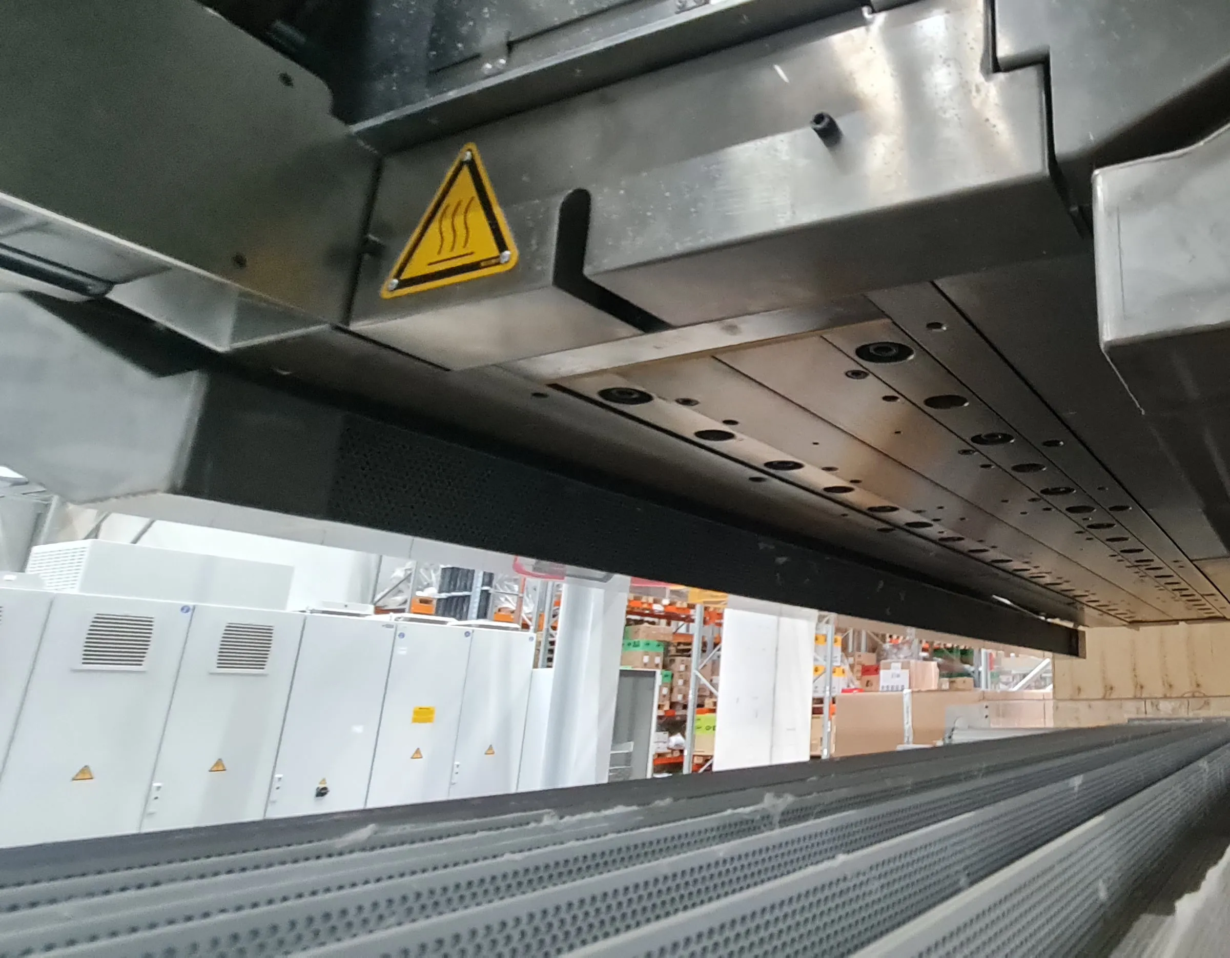 Underside of the die beam with perforated forming grid