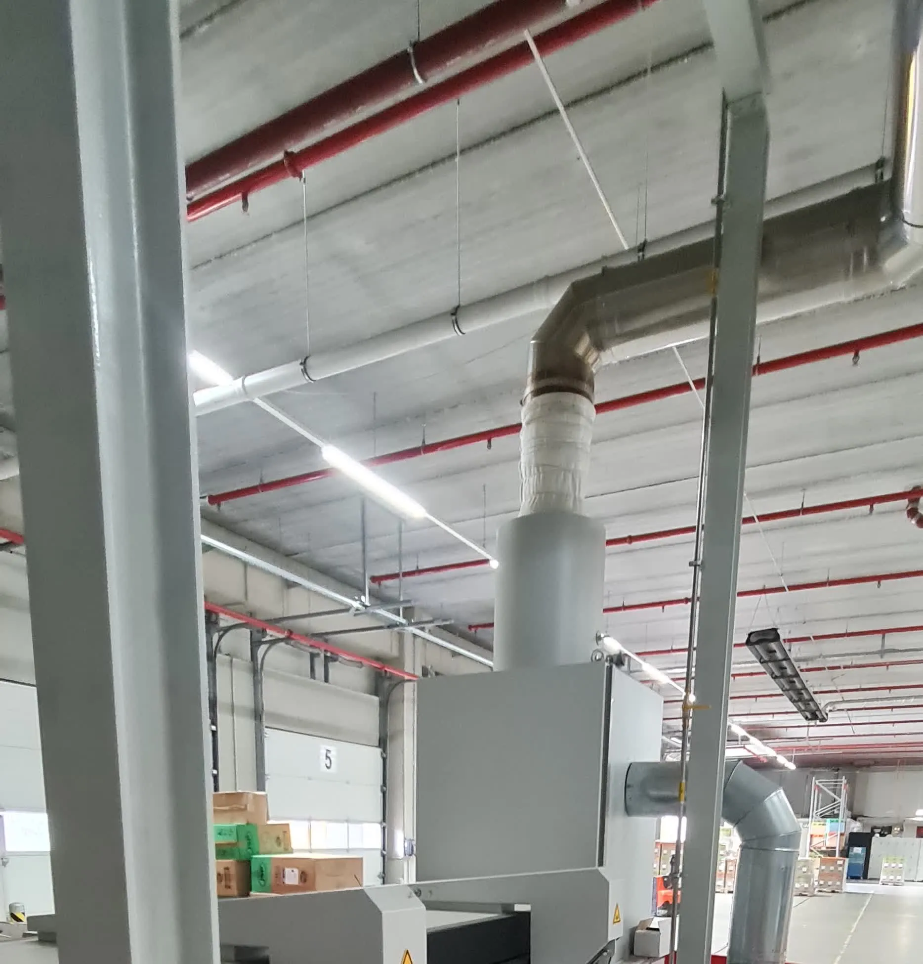 Extraction ducting above the line, warehouse bay in the background