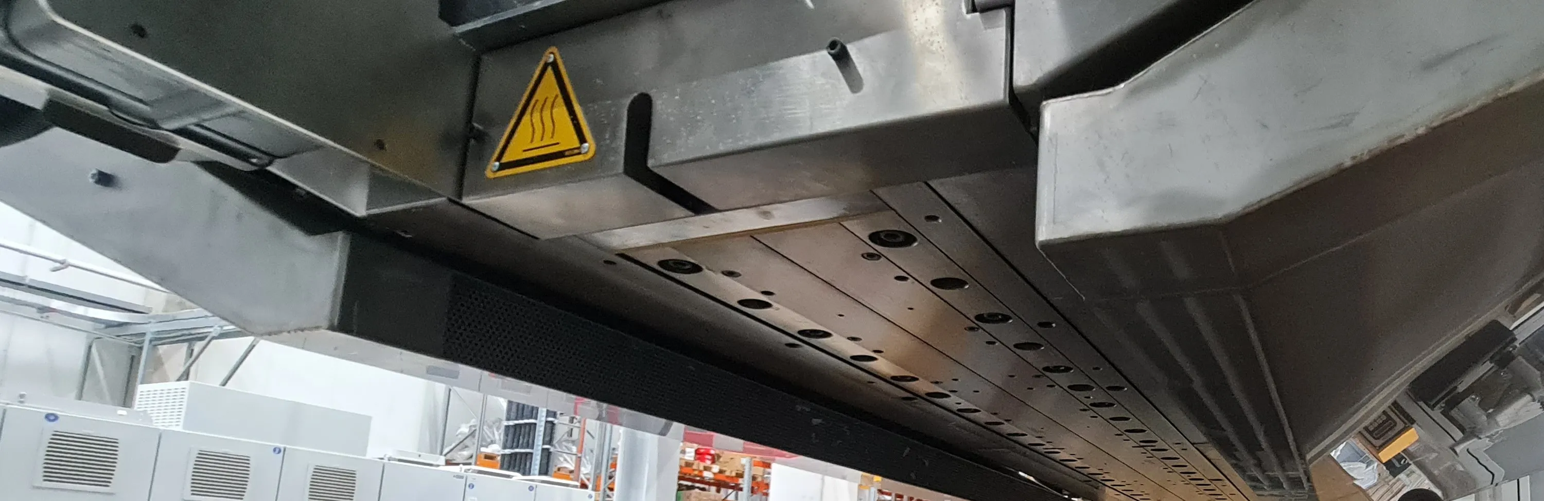 Underside of the meltblown die with hot-surface warning labels