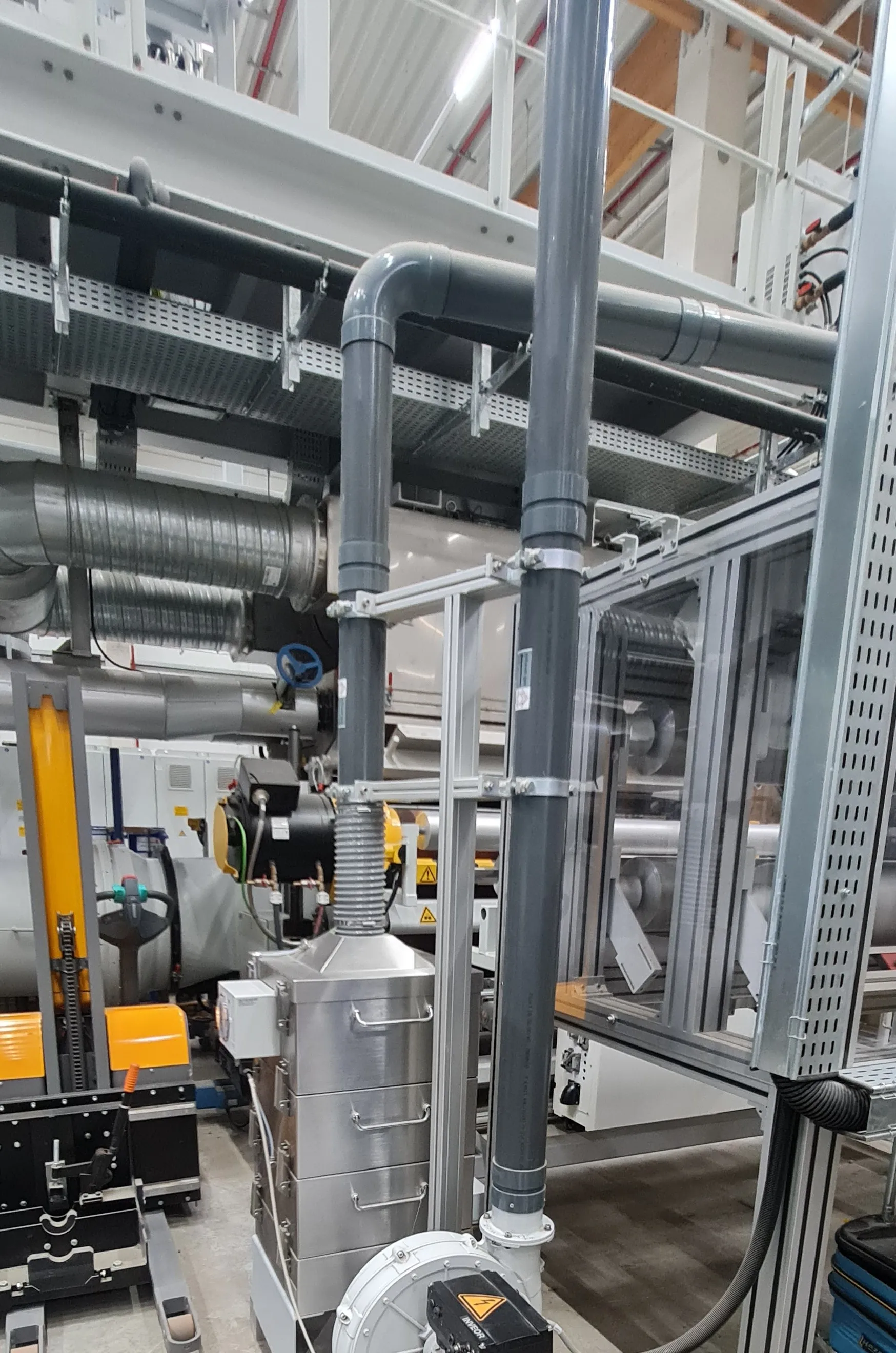 Filter unit and blower beside the line, roll lifting trolley on the left