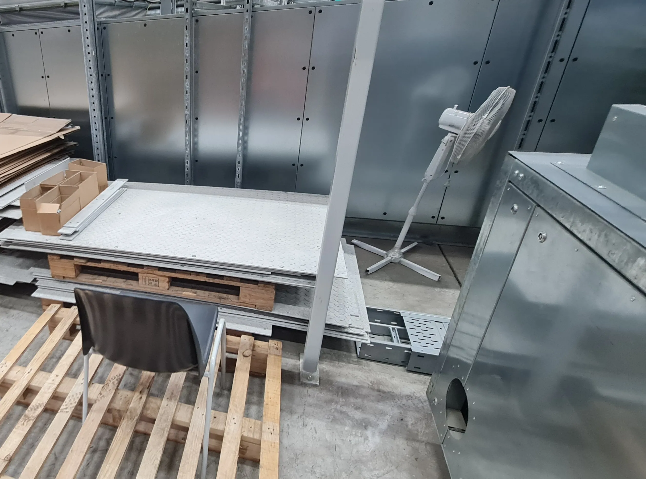 Dismantled enclosure panels, checker plates and cable trays