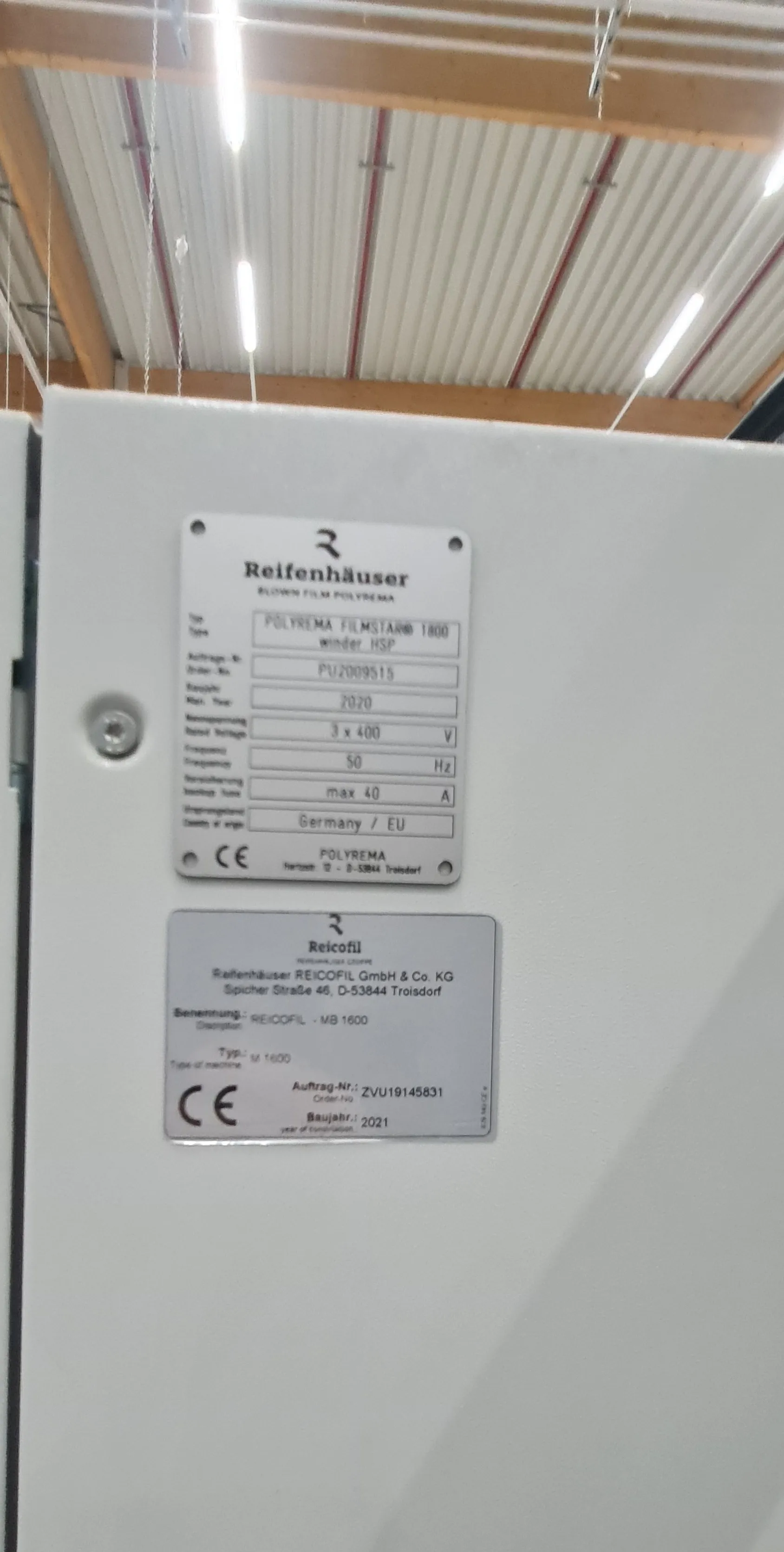 Reifenhäuser nameplates on a cabinet: Polyrema winder HSP and Reicofil MB 1600