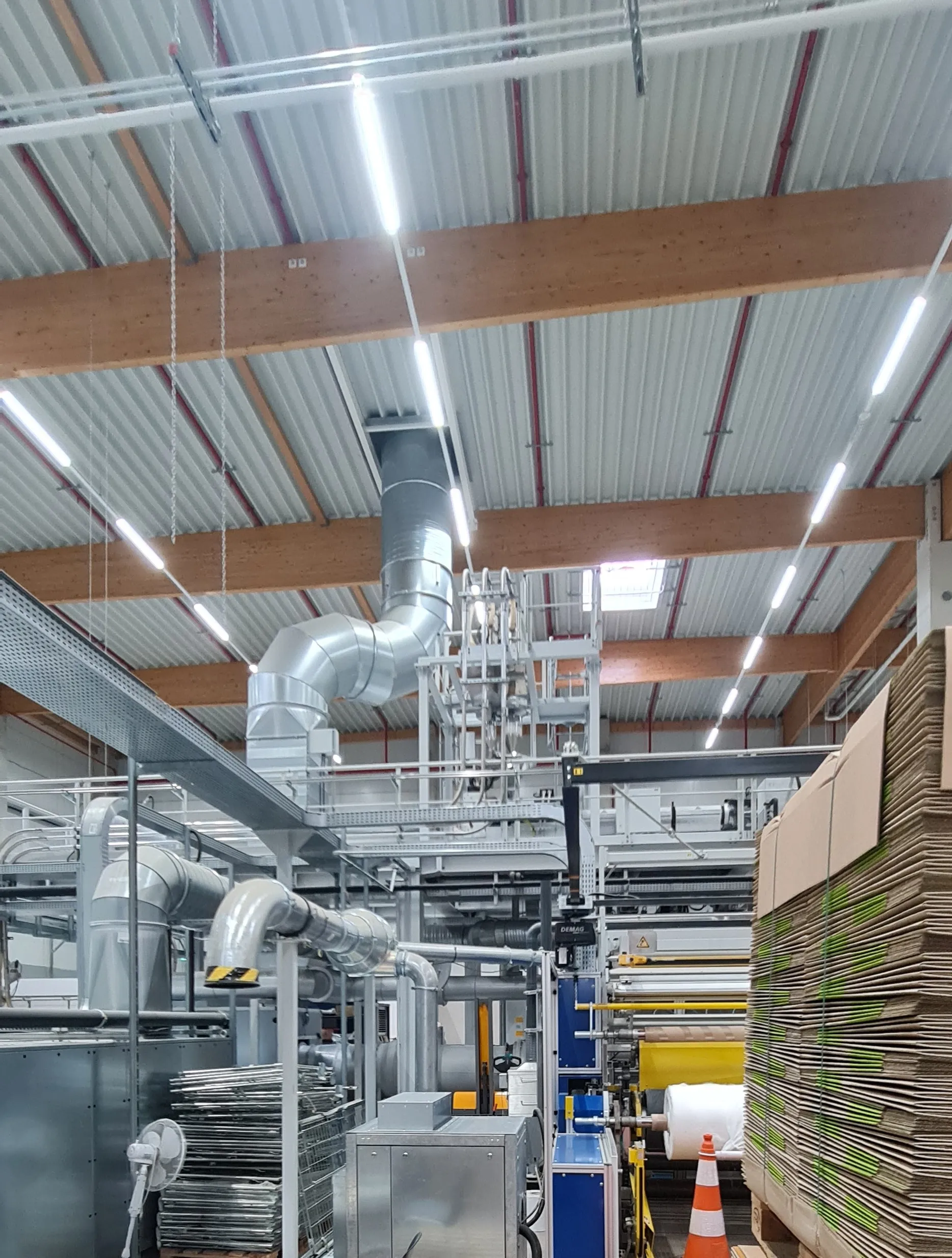 Winder area with a finished roll, hoist and air ducting